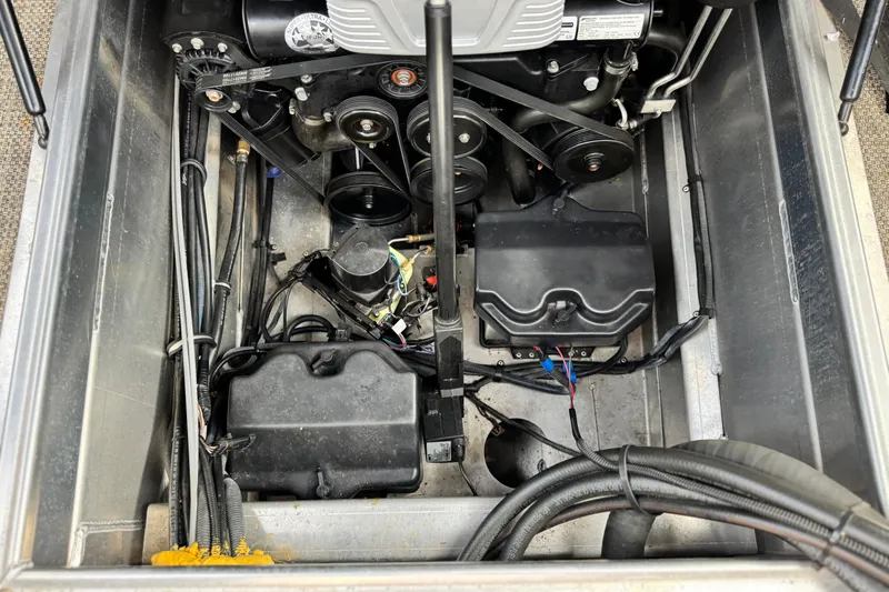 Slide: The Image of Engine compartment of a 2015 Bennington 2575 QCW boat, showing belts and wiring. - 27