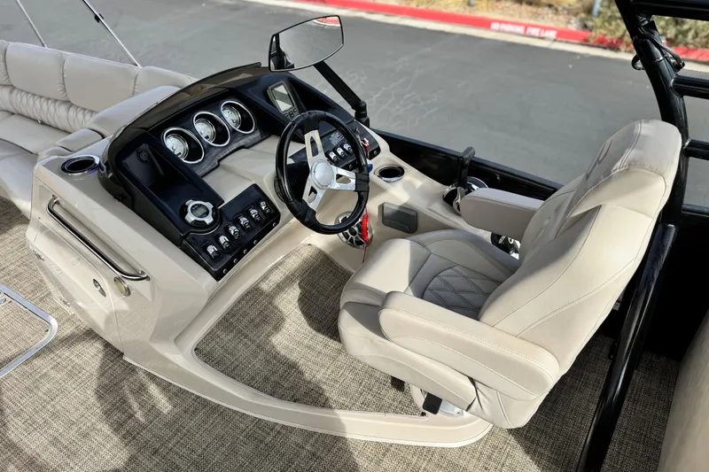Slide: The Image of 2015 Bennington 2575 QCW boat interior with steering wheel and control panel. - 29