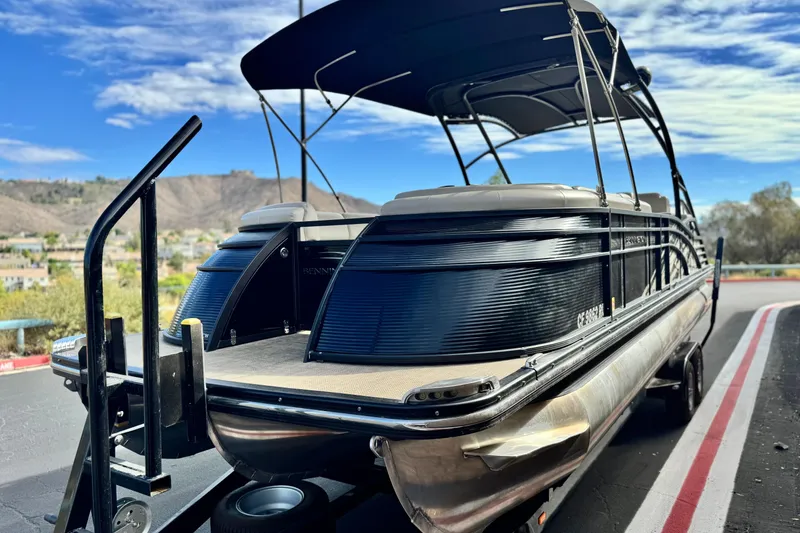 Slide: The Image of 2015 Bennington 2575 QCW pontoon boat on trailer, scenic background. - 3