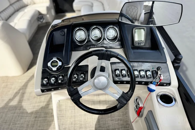 Slide: The Image of Steering console of 2015 Bennington 2575 QCW boat with gauges and controls. - 30