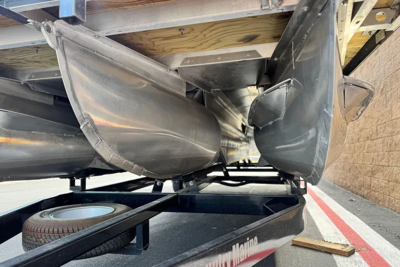 Slide: The Image of Underneath view of a 2015 Bennington 2575 QCW pontoon boat on a trailer. - 4