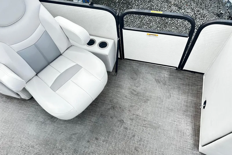 Slide: The Image of 2017 Godfrey Sweetwater 2286 Tri Toon interior with white seating and cup holders. - 9