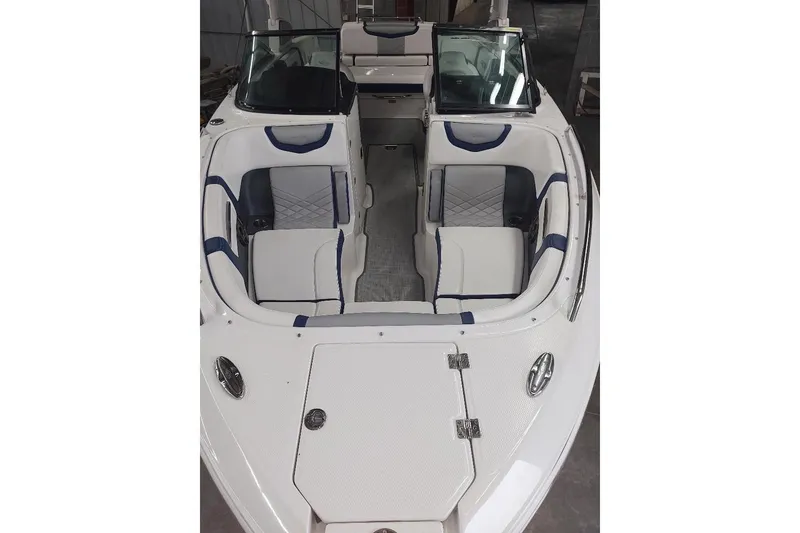 Slide: The Image of 2021 Chaparral 267 SSX boat interior with white and blue seating, open bow design. - 4