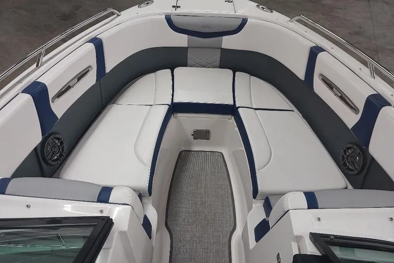 Slide: The Image of 2021 Chaparral 267 SSX boat interior with white and blue seating, modern design. - 7