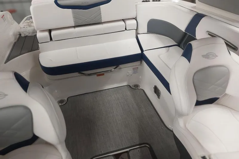 Slide: The Image of 2021 Chaparral 267 SSX boat interior with white and blue seating arrangement. - 8