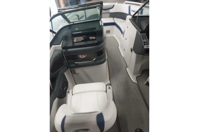 Slide: The Image of Interior of 2021 Chaparral 267 SSX boat with white seating and modern dashboard. - 9