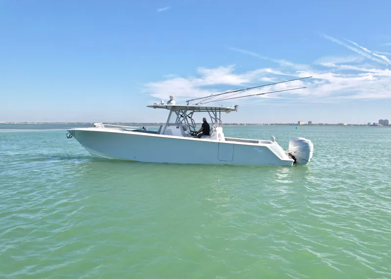 Slide: The Image of 2020 SeaVee 370z boat on calm water under clear blue sky. - 2