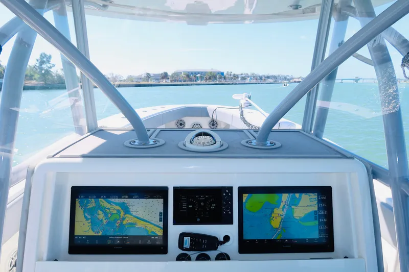 Slide: The Image of 2020 SeaVee 370z boat dashboard with navigation screens, steering, and ocean view. - 22