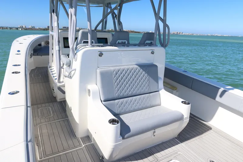 Slide: The Image of 2020 SeaVee 370z boat interior with seating, on calm water, under clear blue sky. - 25