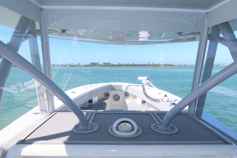 Slide: The Image of 2020 SeaVee 370z boat helm view, navigating clear blue waters. - 28