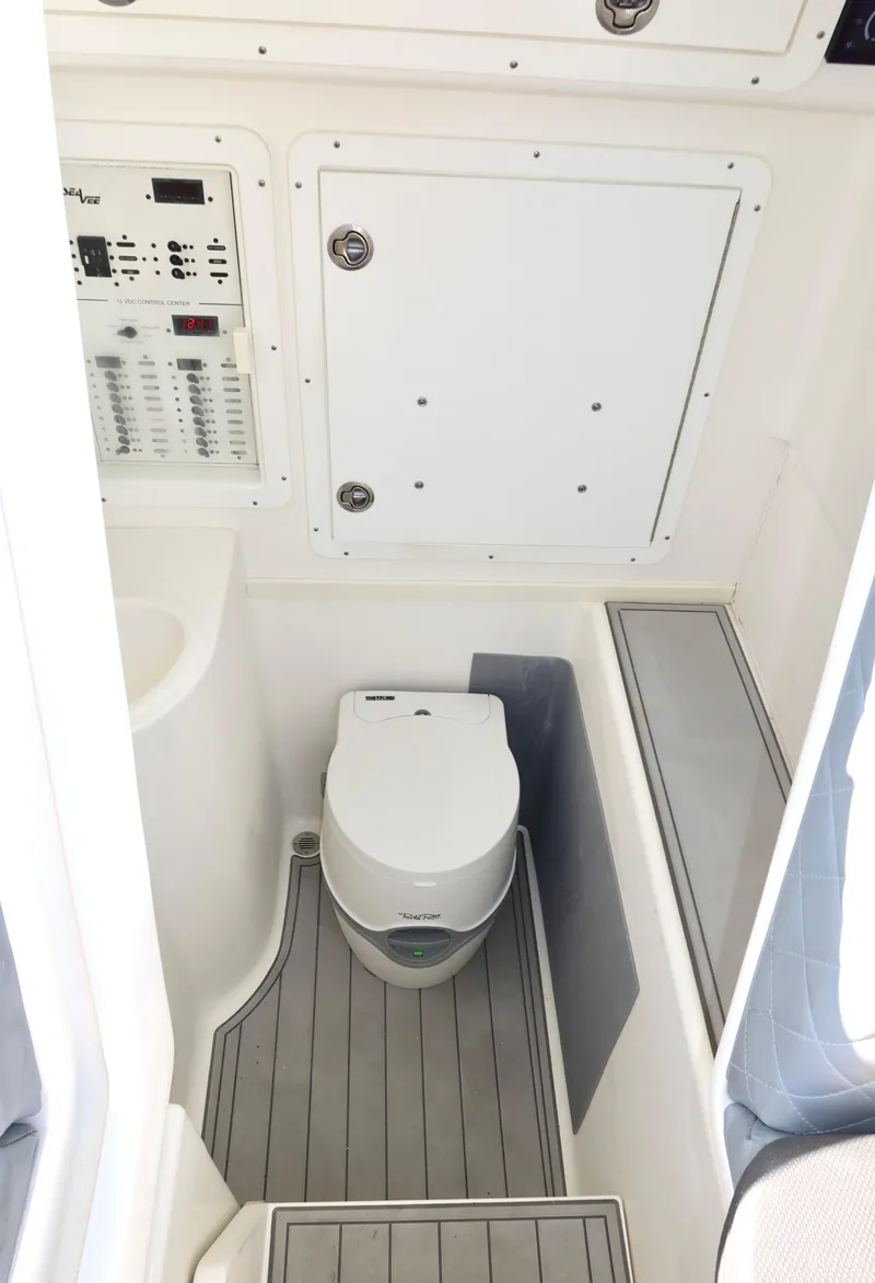 Slide: The Image of 2020 SeaVee 370z boat interior with compact marine toilet and control panel. - 33