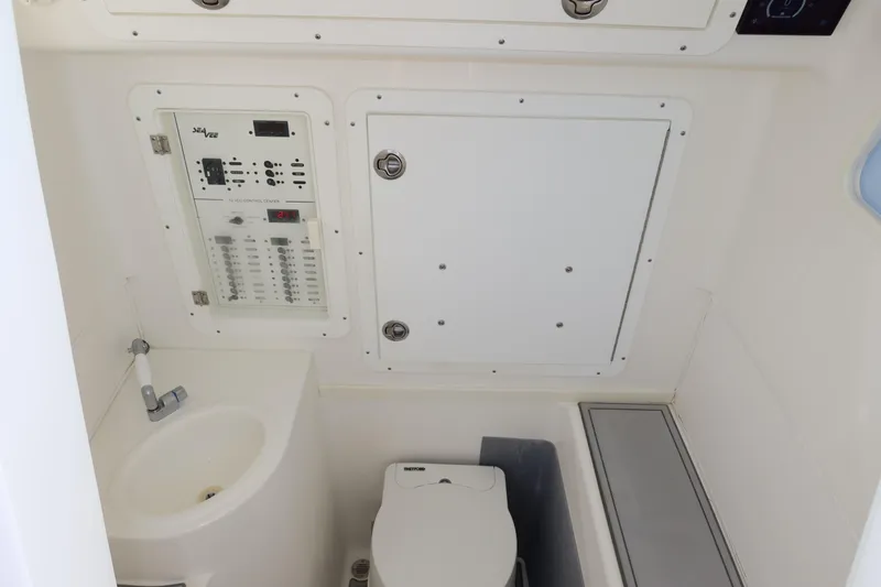 Slide: The Image of 2020 SeaVee 370z boat interior with control panel, sink, and toilet. - 34