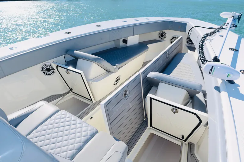 Slide: The Image of 2020 SeaVee 370z boat interior with cushioned seating and storage, on calm blue water. - 38