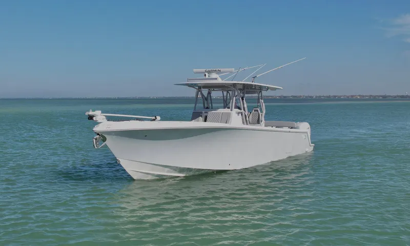 Slide: The Image of 2020 SeaVee 370z boat on calm turquoise waters under clear blue sky. - 5