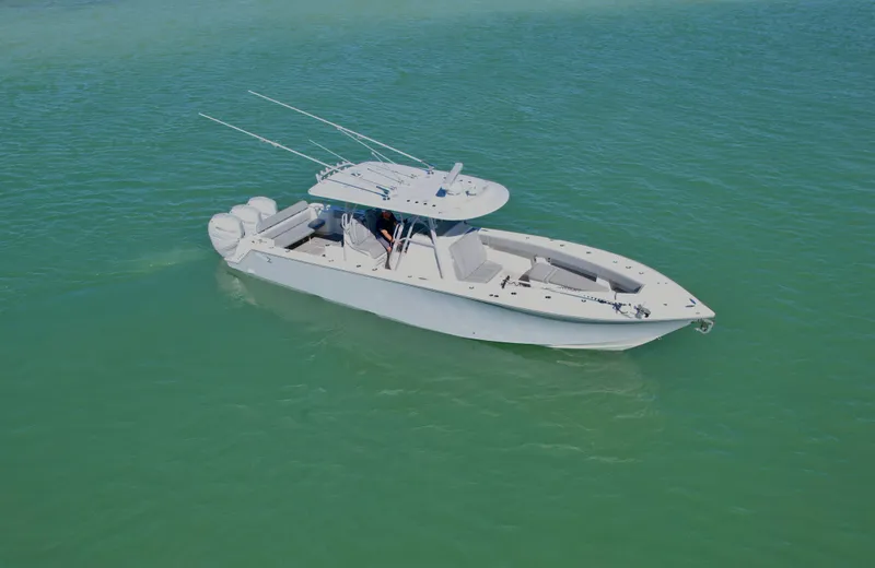 Slide: The Image of 2020 SeaVee 370z boat on calm turquoise water, featuring a sleek design and multiple outboard engines. - 6