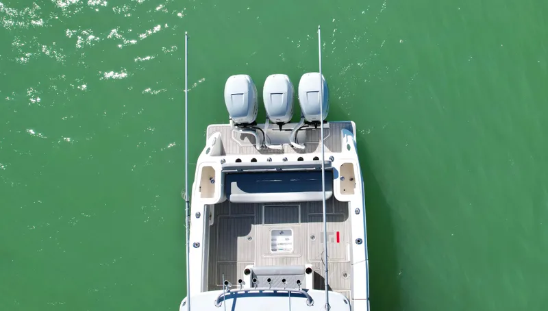 Slide: The Image of Aerial view of 2020 SeaVee 370z boat with triple engines on green water. - 8