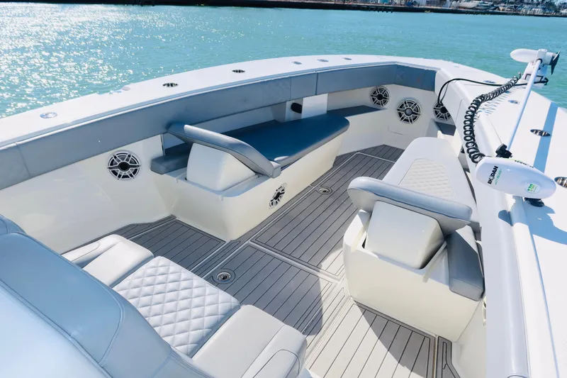 Slide: The Image of 2020 SeaVee 370z boat interior with cushioned seating and modern design on calm water. - 9