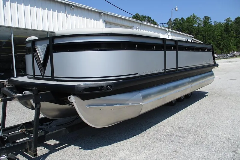 Slide: The Image of 2025 Viaggio Lago X20R pontoon boat on trailer, parked outdoors. - 3