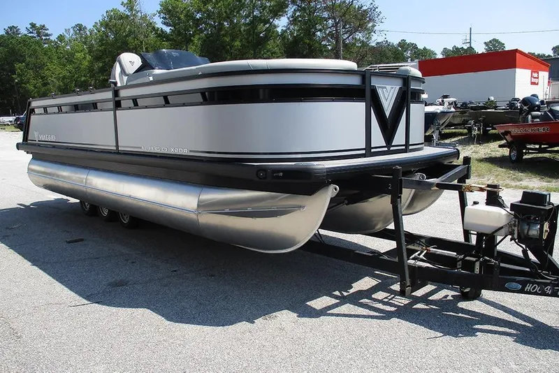 Slide: The Image of 2025 Viaggio Lago X20R pontoon boat on trailer, parked outdoors. - 5