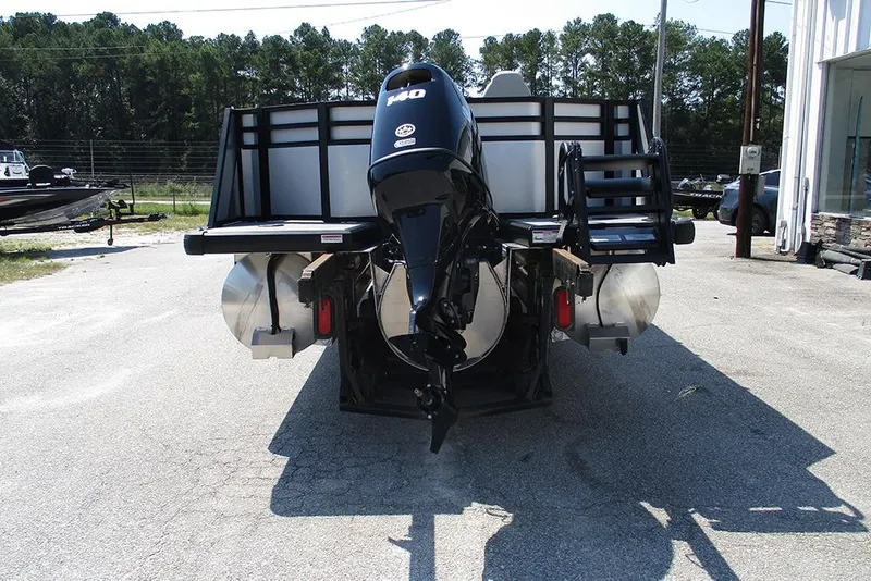 Slide: The Image of 2025 Viaggio Lago X20R pontoon boat with powerful outboard motor, parked outdoors. - 8