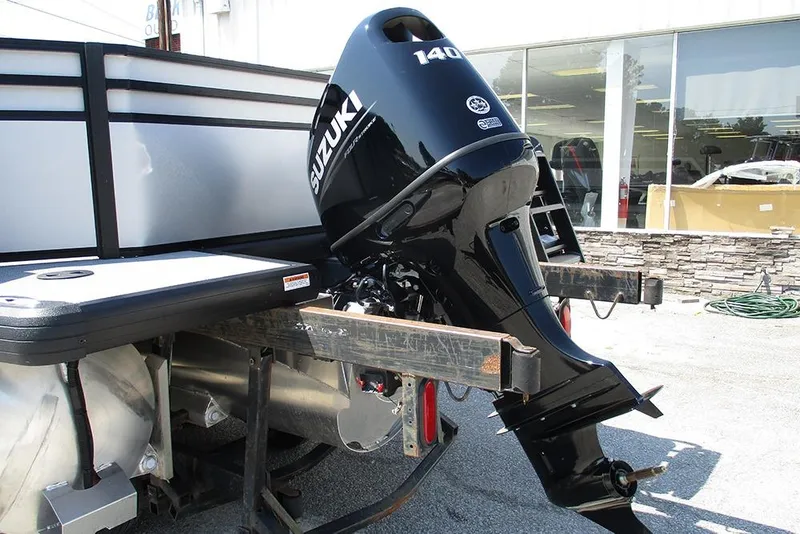 Slide: The Image of 2025 Viaggio Lago X20R with Suzuki outboard motor, parked outside a showroom. - 9