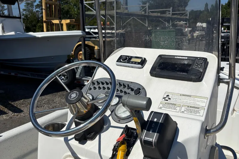 Slide: The Image of 2014 Carolina Skiff JVX18CC boat console with steering wheel and navigation equipment. - 2