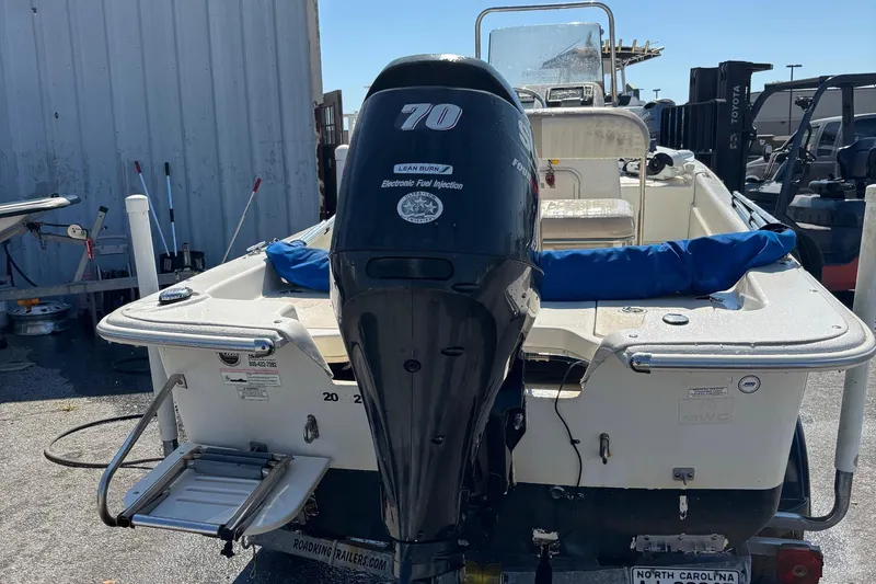 Slide: The Image of 2014 Carolina Skiff JVX18CC boat with 70HP outboard motor, parked outdoors. - 3