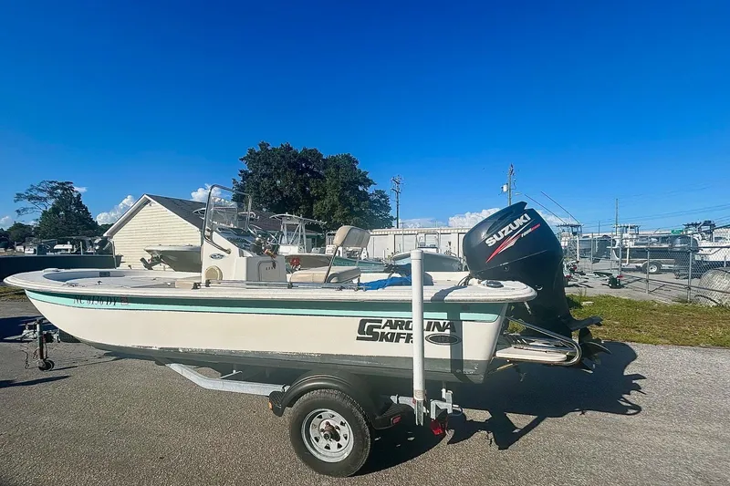 Slide: The Image of 2014 Carolina Skiff JVX18CC boat on trailer with Suzuki outboard motor. - 4
