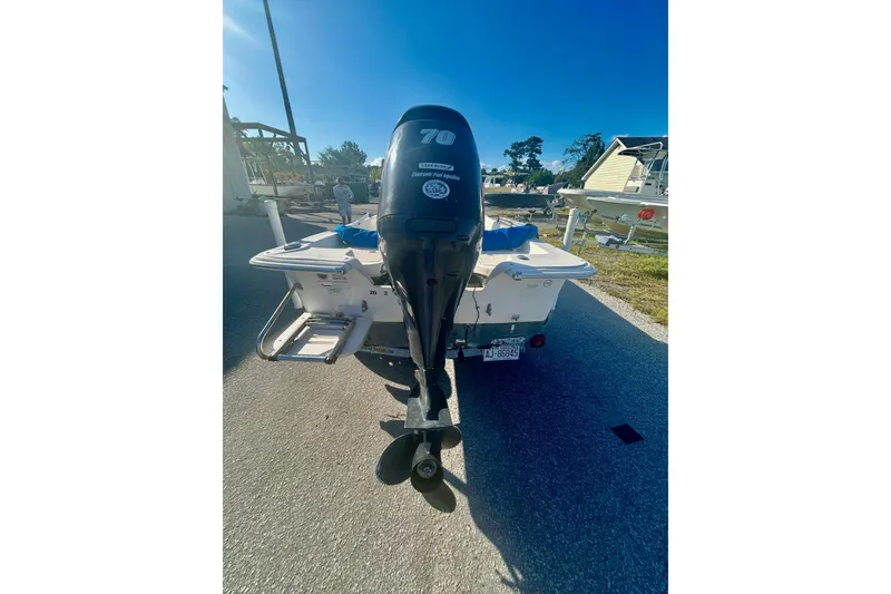 Slide: The Image of 2014 Carolina Skiff JVX18CC boat with Yamaha 70 outboard motor, parked outdoors. - 5