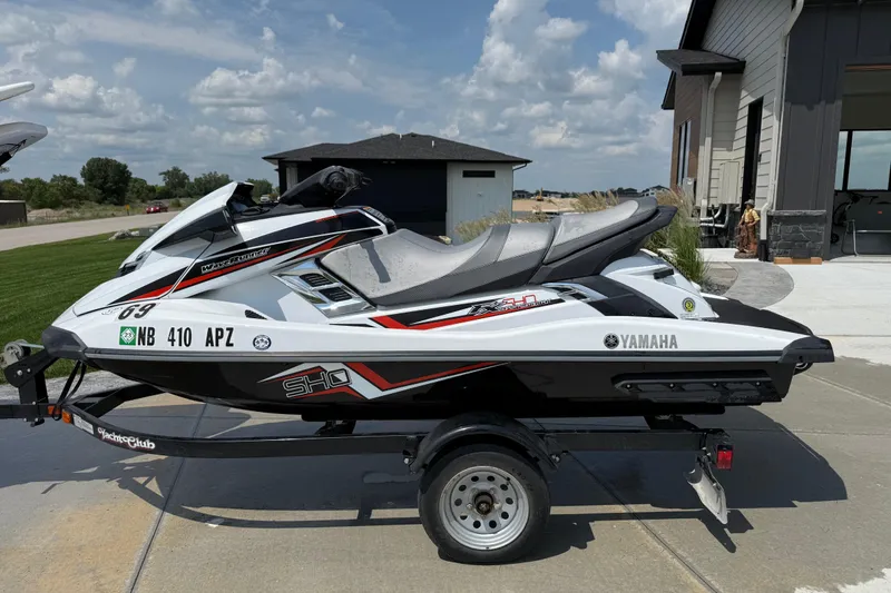 The Image of 2014 Yamaha WaveRunner FX SHO jet ski on trailer, parked outdoors. - 1
