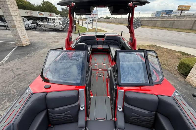 Slide: The Image of 2026 Supra SE 550 boat interior with sleek red and black design, spacious seating, and modern features. - 14