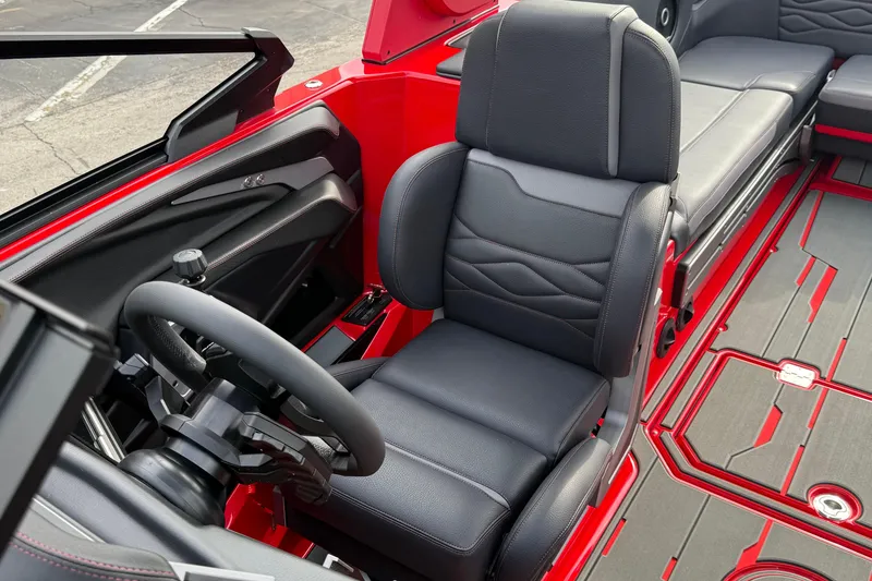 Slide: The Image of 2026 Supra SE 550 boat interior with black leather seats and red accents. - 18