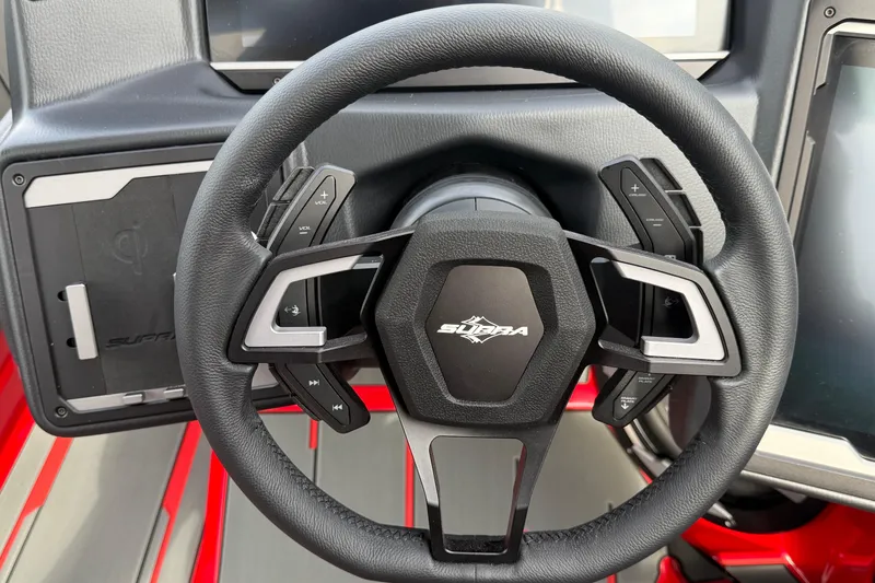 Slide: The Image of Steering wheel of 2026 Supra SE 550 boat with control buttons and logo. - 21