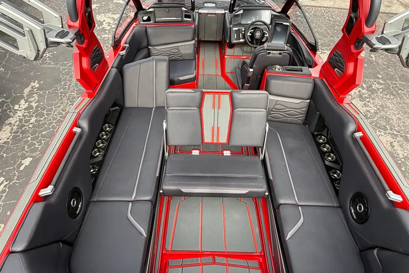 Slide: The Image of 2026 Supra SE 550 boat interior with red accents and luxurious seating. - 25