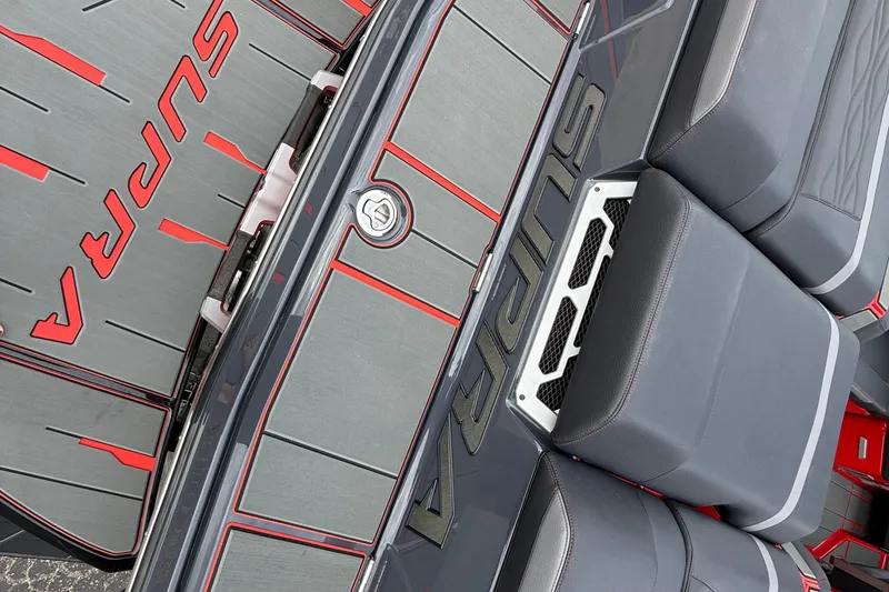 Slide: The Image of 2026 Supra SE 550 boat interior with sleek gray and red design accents. - 7