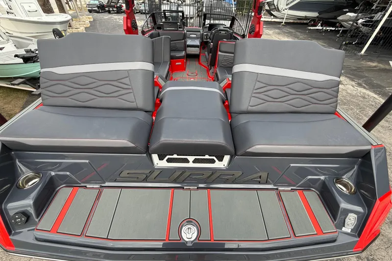 Slide: The Image of 2026 Supra SE 550 boat interior with gray and red seating, showcasing modern design. - 9