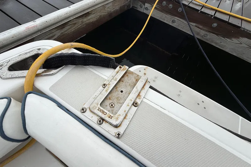 Slide: The Image of 2005 Back Cove 26 boat docked, showing deck details and mooring lines. - 16