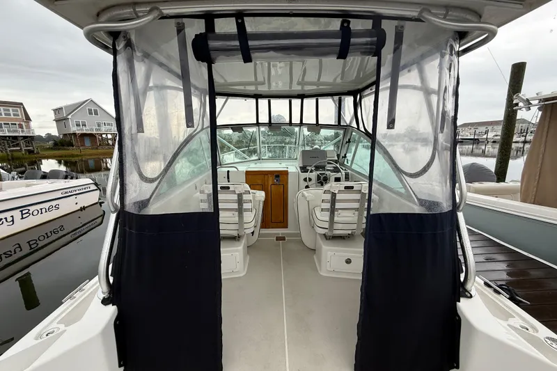 Slide: The Image of 2005 Back Cove 26 boat interior with clear canopy and steering area. - 21