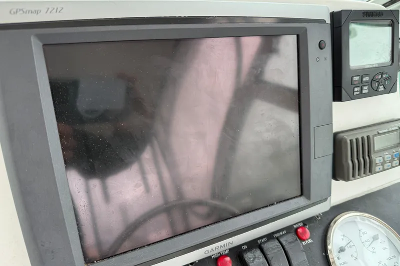 Slide: The Image of 2005 Back Cove 26 boat dashboard with GPSmap 7212 and navigation instruments. - 27