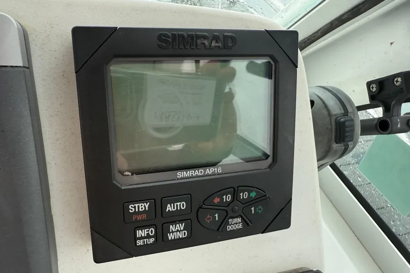Slide: The Image of Simrad AP16 autopilot display on 2005 Back Cove 26 boat dashboard. - 29