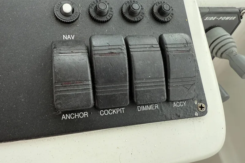 Slide: The Image of Control panel of a 2005 Back Cove 26 boat with labeled switches. - 33