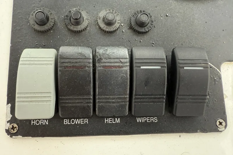 Slide: The Image of Control panel of a 2005 Back Cove 26 boat with labeled switches. - 34