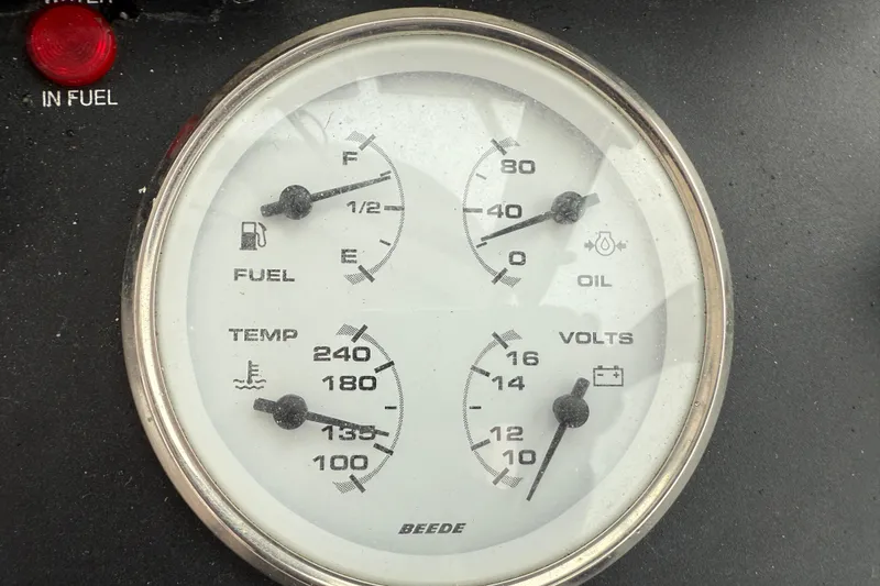 Slide: The Image of Close-up of 2005 Back Cove 26 boat gauge panel displaying fuel, oil, temperature, and voltage levels. - 36
