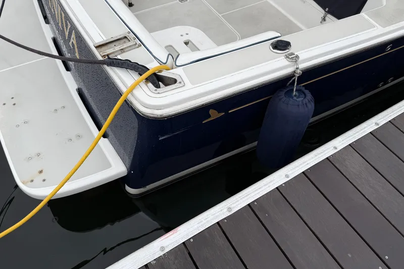 Slide: The Image of 2005 Back Cove 26 boat docked with fender and power cable. - 4