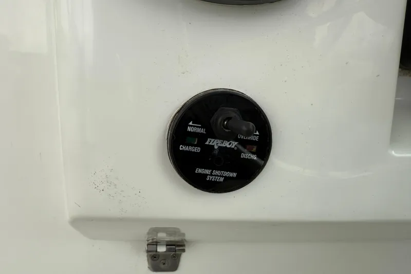 Slide: The Image of Fireboy engine shutdown system on 2005 Back Cove 26 boat, featuring override and discharge settings. - 42