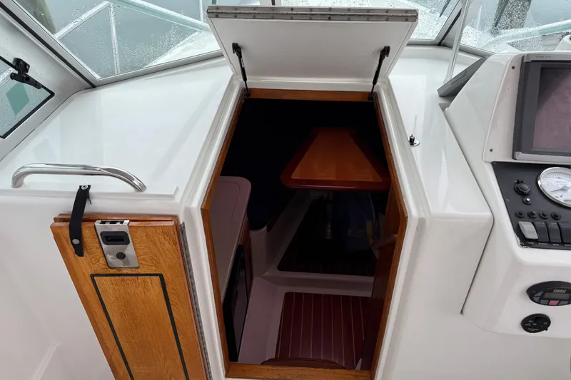 Slide: The Image of 2005 Back Cove 26 boat cabin entrance with wooden door and control panel. - 43