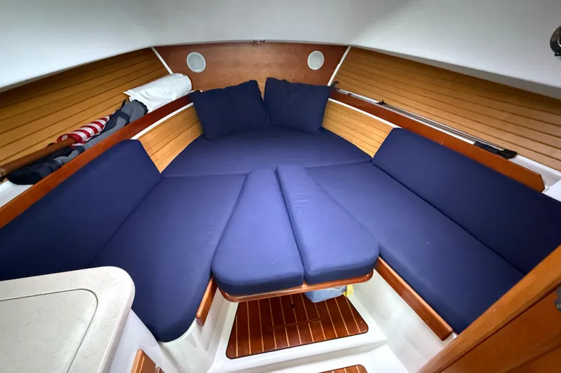 Slide: The Image of 2005 Back Cove 26 boat interior with blue cushions and wooden accents. - 47