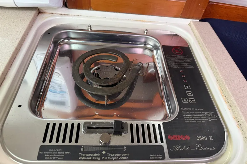 Slide: The Image of 2005 Back Cove 26 boat stove with alcohol burner and electronic controls. - 53