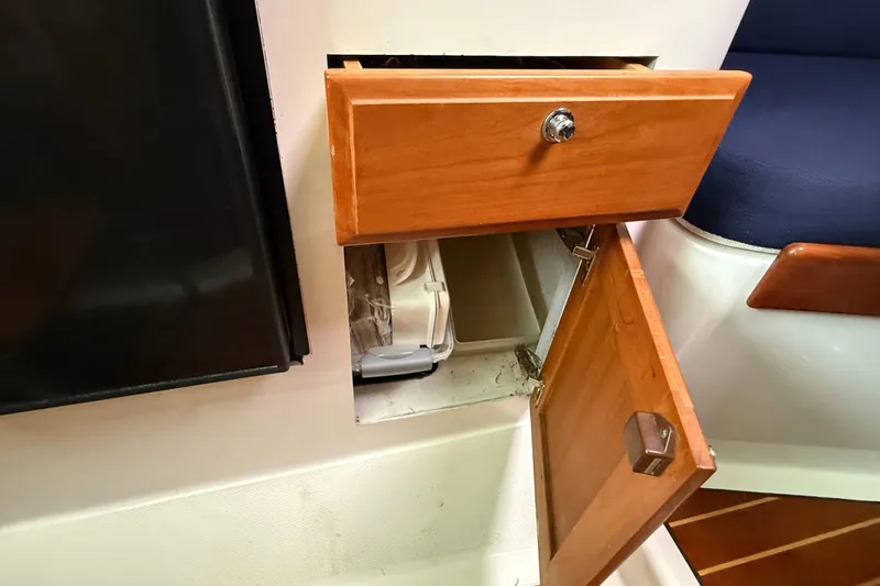 Slide: The Image of Open wooden cabinet and drawer on 2005 Back Cove 26 boat interior. - 55