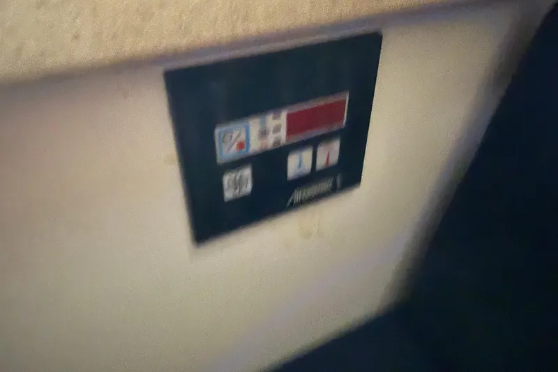 Slide: The Image of Control panel inside a 2005 Back Cove 26 boat, featuring buttons and display. - 60